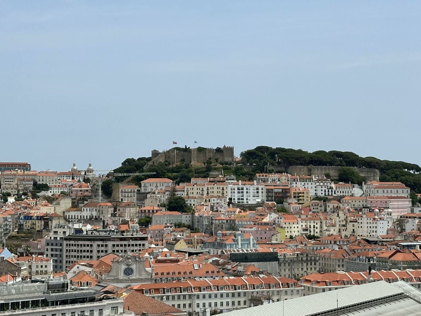 The terracotta rooftops and hilltop castle of Lisbon's historic centre — one of the most popular places Americans move abroad